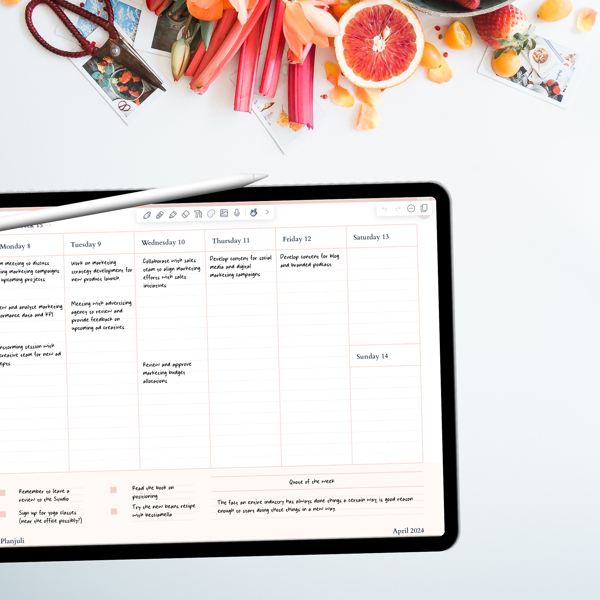 A desk with an ipad open to a digital planner in GoodNotes and a Apple Pencil